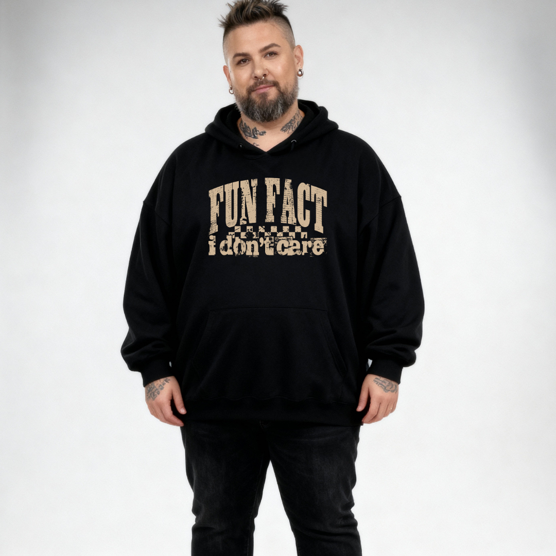 Front view of a man wearing black Fun Fact I Don't Care hoodie, relaxed fit, bold distressed slogan print, plus size Australian streetwear by Bae Bands