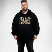 Front view of a man wearing black Fun Fact I Don't Care hoodie, relaxed fit, bold distressed slogan print, plus size Australian streetwear by Bae Bands