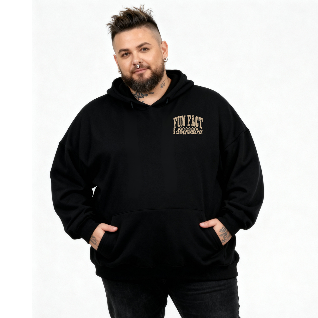 A man wearing black oversized graphic hoodie with Fun Fact I Don't Care distressed varsity text DTF print, plus size Australian streetwear by Bae Bands