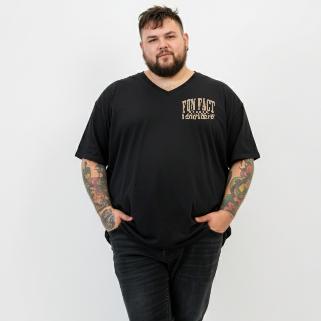 Front view of a man wearing black Fun Fact I Don't Care v neck tee, relaxed fit, bold distressed slogan print, plus size Australian streetwear by Bae Bands