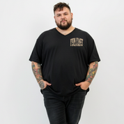 Front view of a man wearing black Fun Fact I Don't Care v neck tee, relaxed fit, bold distressed slogan print, plus size Australian streetwear by Bae Bands
