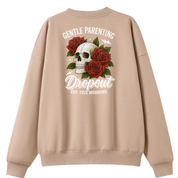 A beige crewneck sweatshirt shown from the back, featuring a graphic print of a white skull surrounded by red roses and the text 'GENTLE PARENTING Dropout EST. THIS MORNING'.