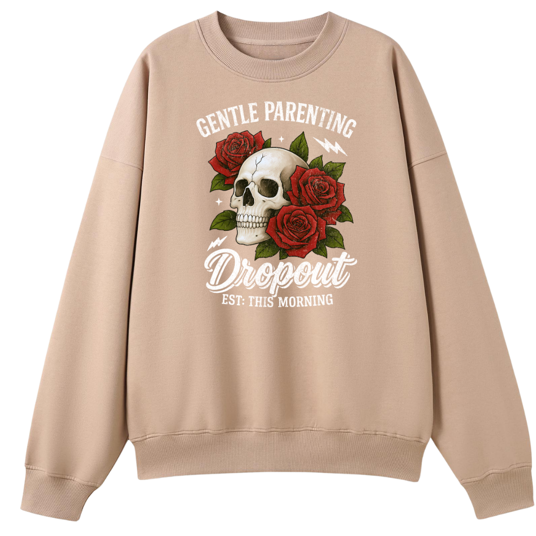 A beige crewneck sweatshirt featuring a graphic print of a skull surrounded by red roses and the text 'GENTLE PARENTING Dropout EST. THIS MORNING'.