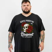 A man wearing a black V-neck t-shirt with a graphic print featuring a skull, red roses, and the text 'GENTLE PARENTING Dropout EST. THIS MORNING'.