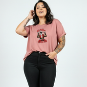 Person wearing a pink t-shirt with a graphic design on a white background