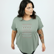 Woman wearing a green t-shirt with a pattern on a white background