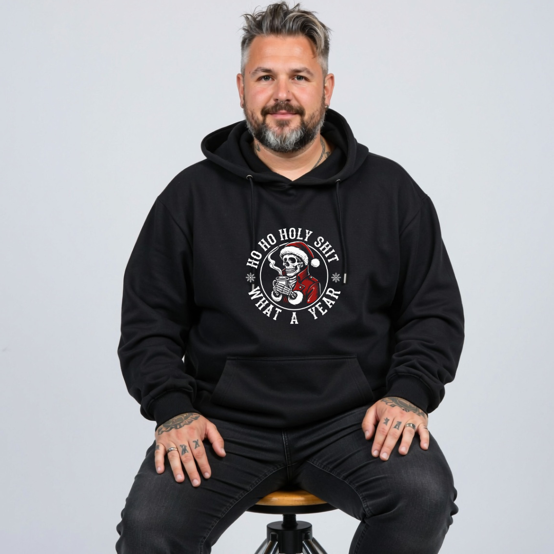 Man wearing a black hoodie with a graphic design on a gray background