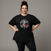 Person wearing a black t-shirt with a graphic design on a gray background