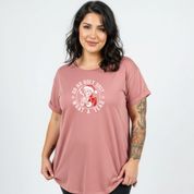 Woman wearing a pink t-shirt with a graphic design on a white background