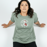 Woman wearing a green t-shirt with a graphic design on a white background