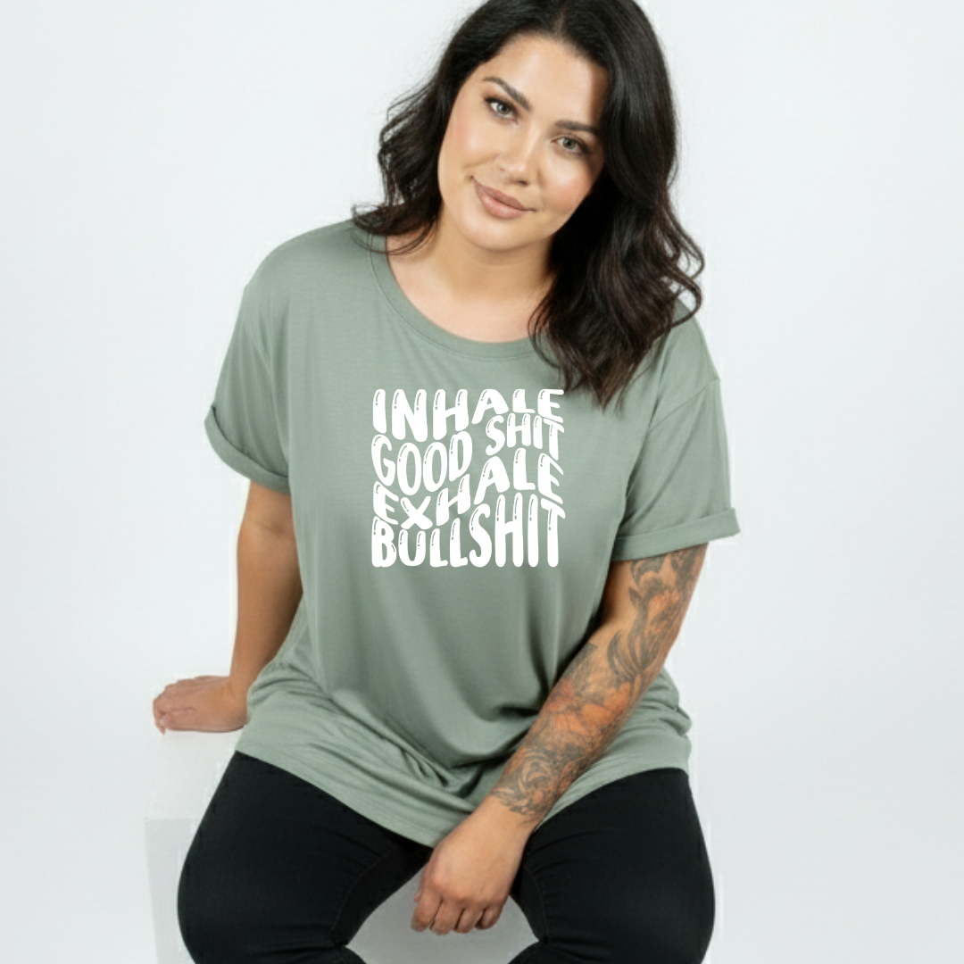 Close up of Inhale Good Shit Exhale Bullshit DTF print on slate green oversized tee, bold wavy white typography, Bae Bands Australia