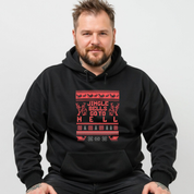 Man wearing a black hoodie with red text and patterns on a plain background