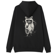 A black pullover hoodie shown from the back, featuring a distressed white graphic print of a raccoon holding up a middle finger, set against a plain white background.