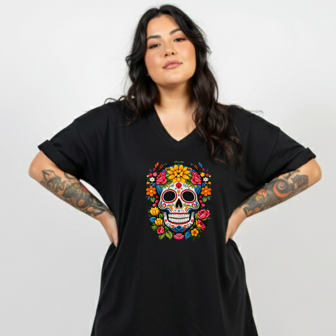 Woman wearing a black t-shirt with a colorful skull design on a plain background