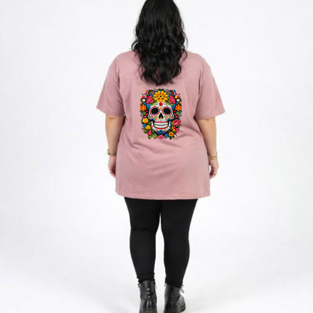 Person wearing a pink t-shirt with a colorful skull design on the back, standing against a white background.