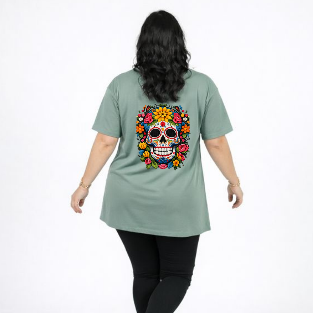Person wearing a light green t-shirt with a colorful skull design on the back, on a white background.