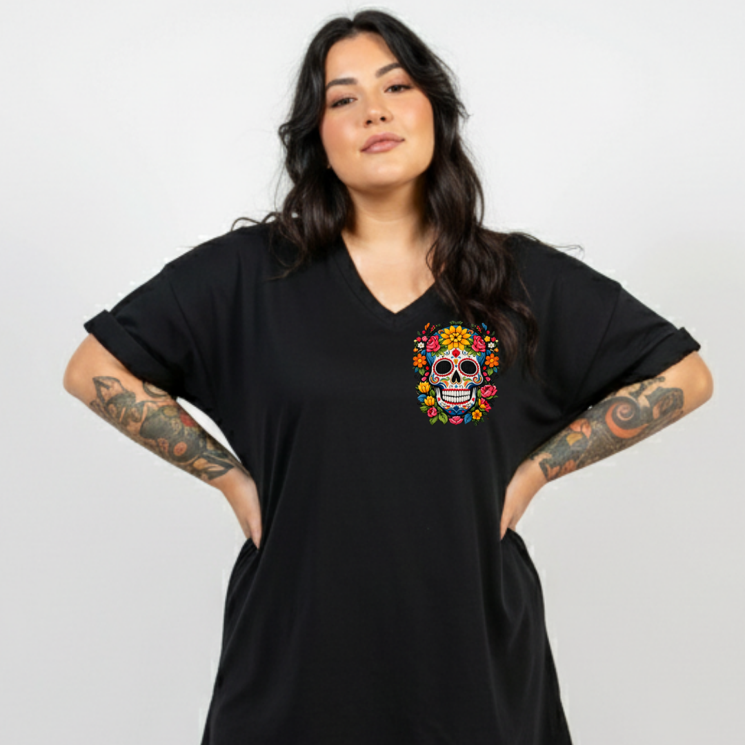 Woman wearing a black t-shirt with a colorful skull design on a plain background