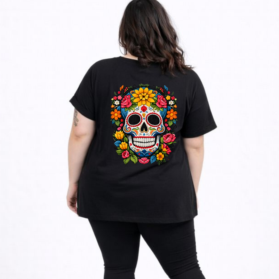 Person wearing a black t-shirt with a colorful skull design on the back.