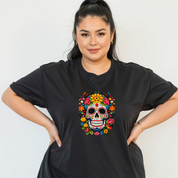 Woman wearing a black t-shirt with a colorful skull design on a plain background
