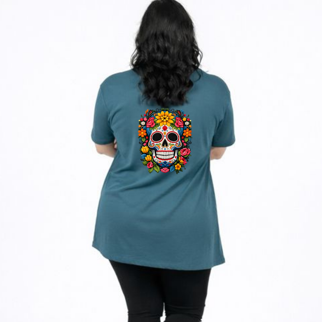Person wearing a teal t-shirt with a colorful skull design on the back.