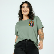 Woman wearing a green t-shirt with a colorful skull design on a white background