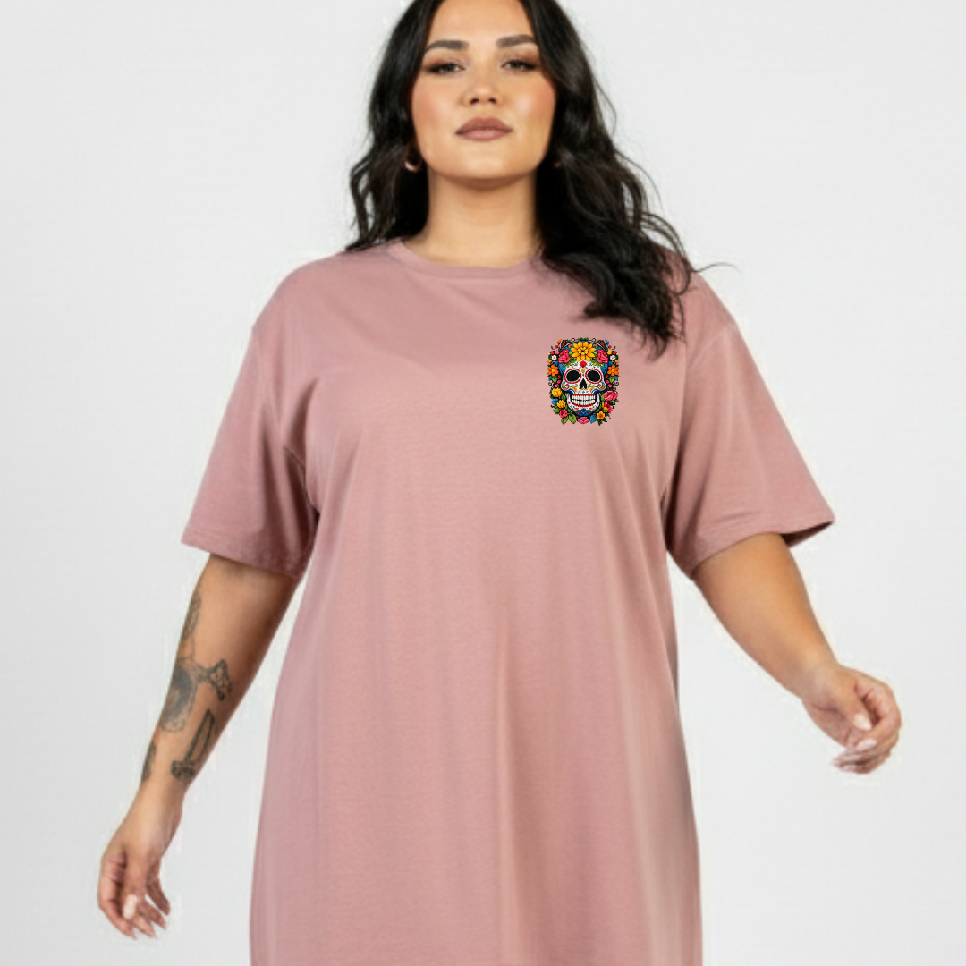 Woman wearing a pink t-shirt with a colorful skull design on a plain background