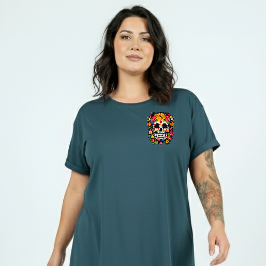 Woman wearing a teal t-shirt with a colorful skull design on a plain background