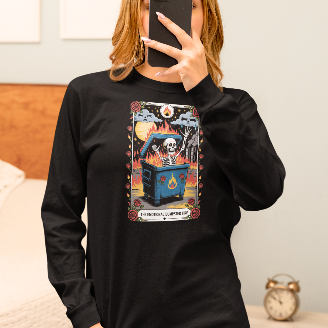 Person wearing a black sweatshirt with a graphic design, taking a mirror selfie.