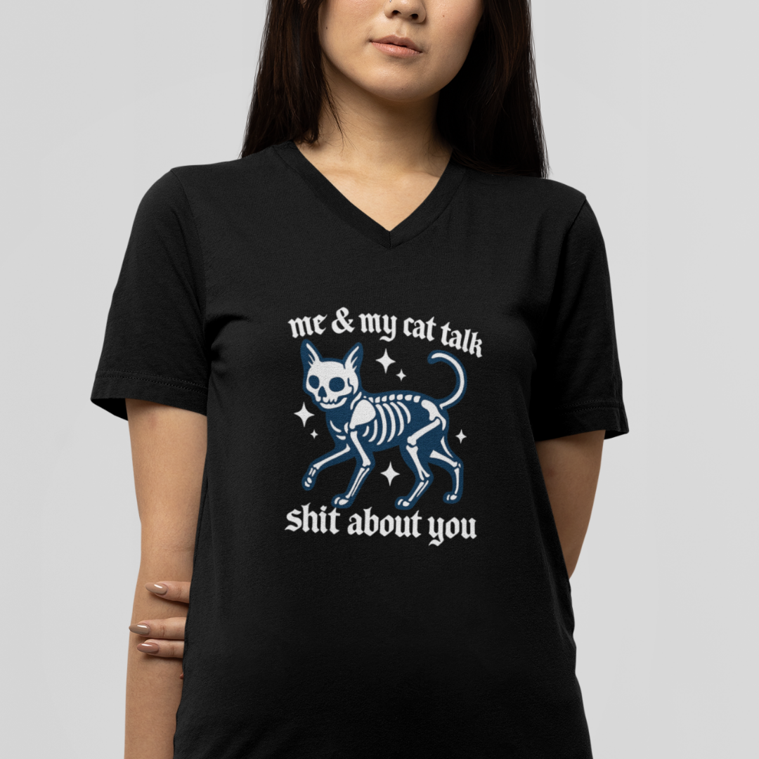 Person wearing a black t-shirt with a graphic and text on a plain background