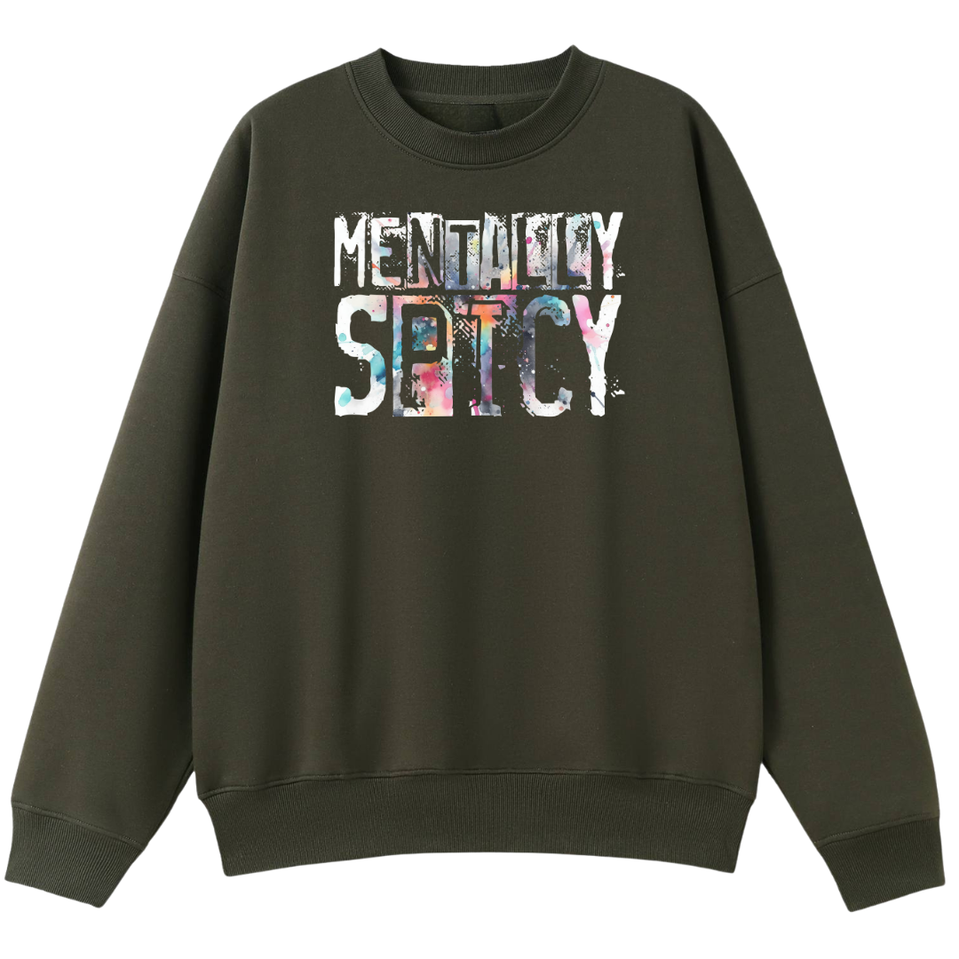 An olive green crewneck sweatshirt featuring a colorful graphic print on the front that reads 'MENTALLY SPICY' in a distressed, paint-splattered font.