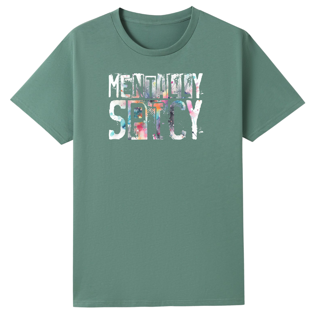 A sage green short-sleeve t-shirt with a graphic on the chest reading 'MENTAL DAY SETCY' in a textured, multicolored watercolor style, displayed on a solid white background.