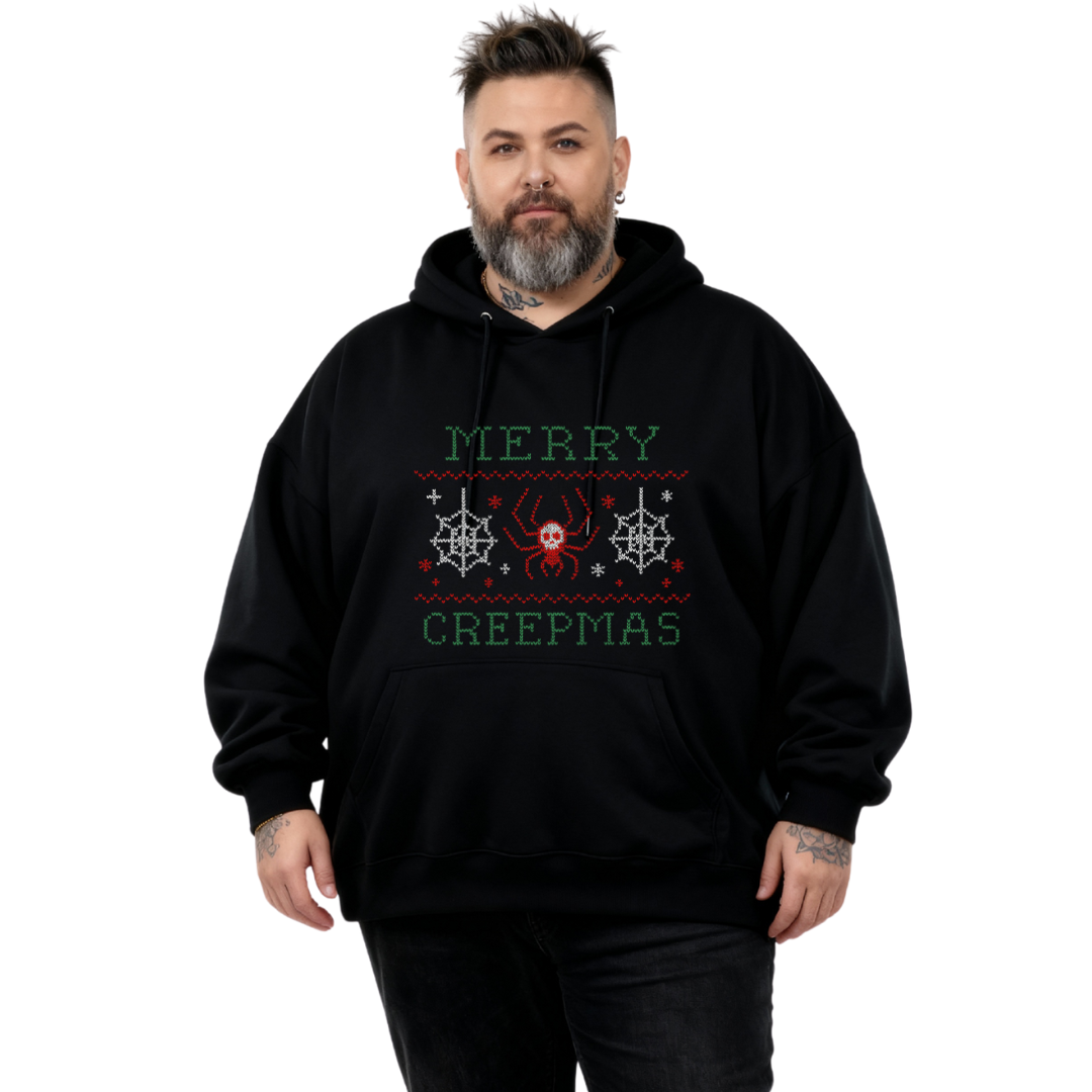 Person wearing a black hoodie with 'Merry Creepmas' text and spider design on a white background