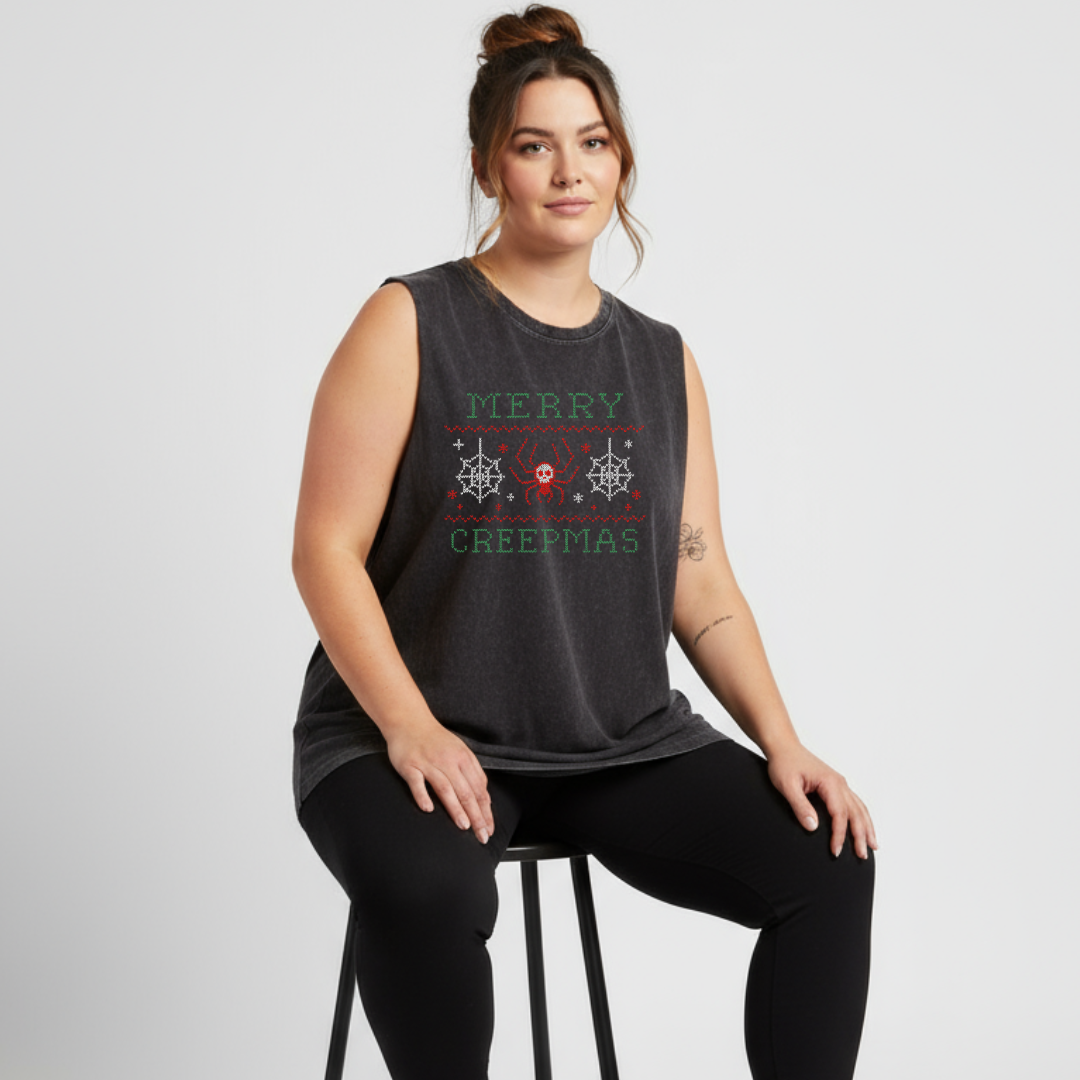Woman wearing a black sleeveless shirt with festive text design on a white background