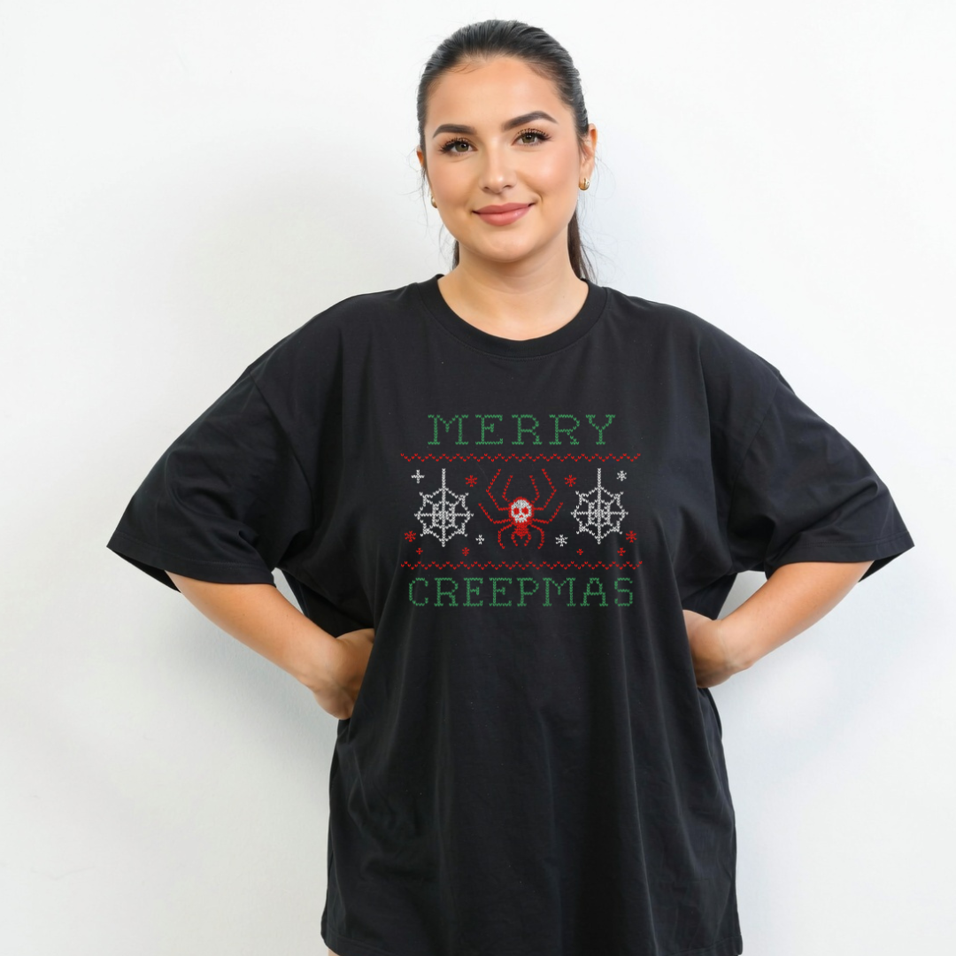 Person wearing a black t-shirt with 'Merry Creepmas' design on a white background