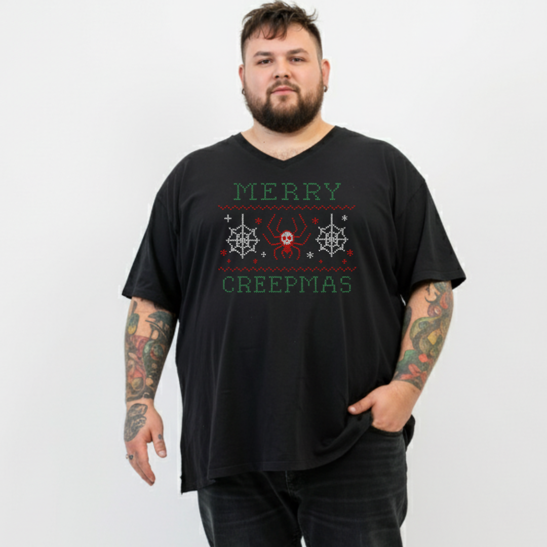 Man wearing a black t-shirt with 'Merry Creepmas' text and graphics on a white background