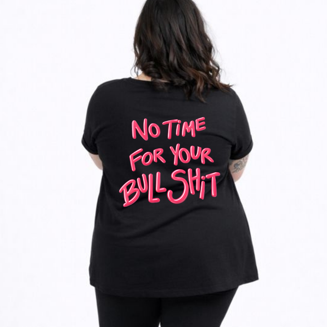Person wearing a black t-shirt with pink text on the back against a white background