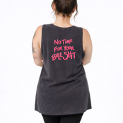 Person wearing a black tank top with pink text on the back against a white background