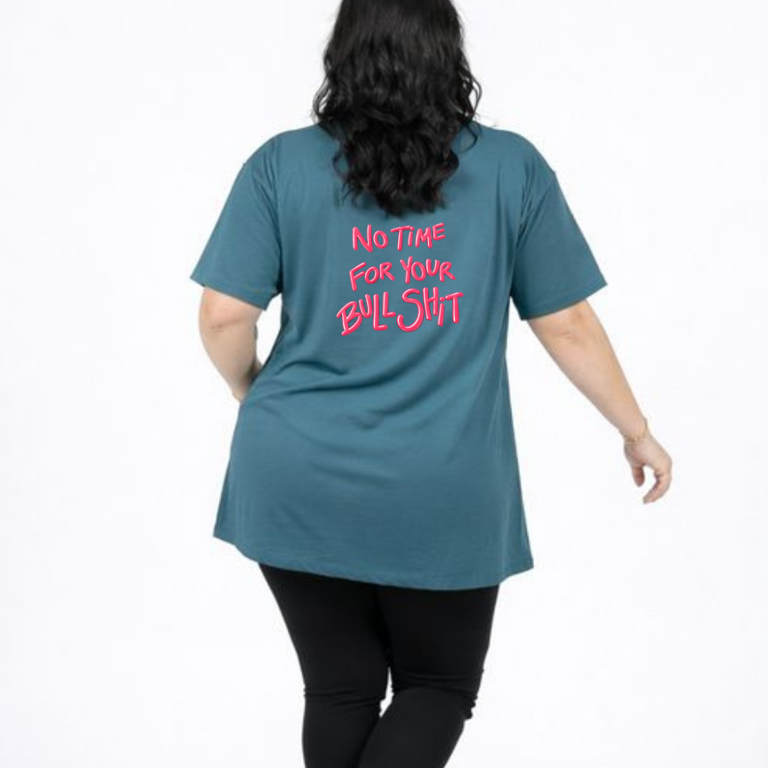 Person wearing a teal t-shirt with pink text on the back, standing against a white background