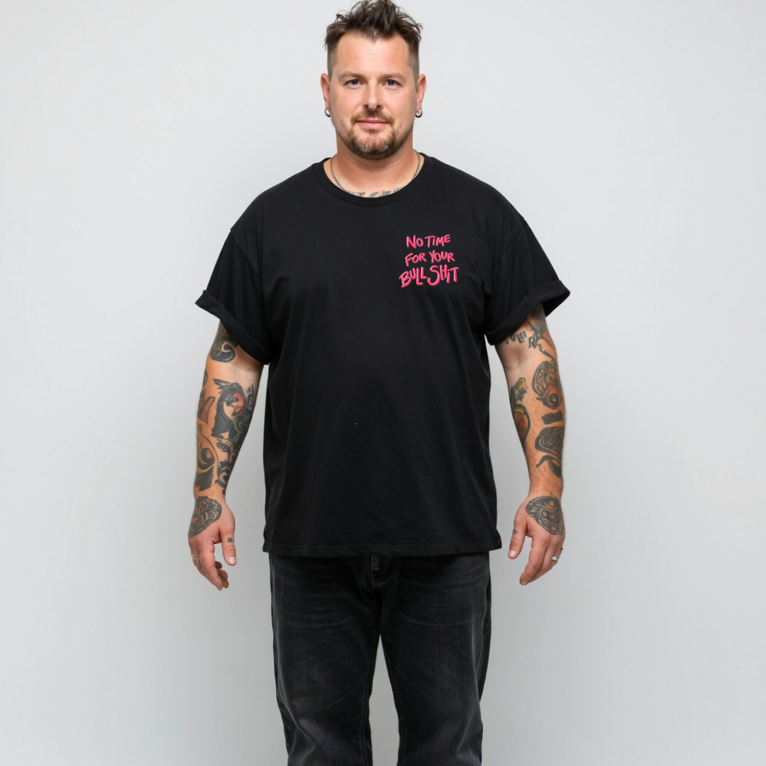 Man wearing a black t-shirt with pink text on a white background
