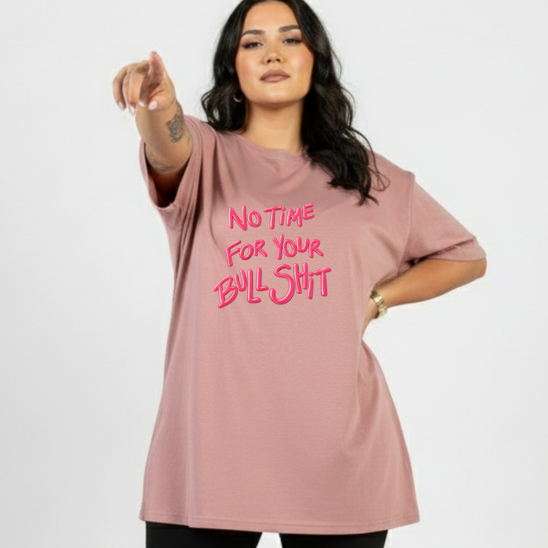 Woman wearing a pink t-shirt with a bold text design on a white background