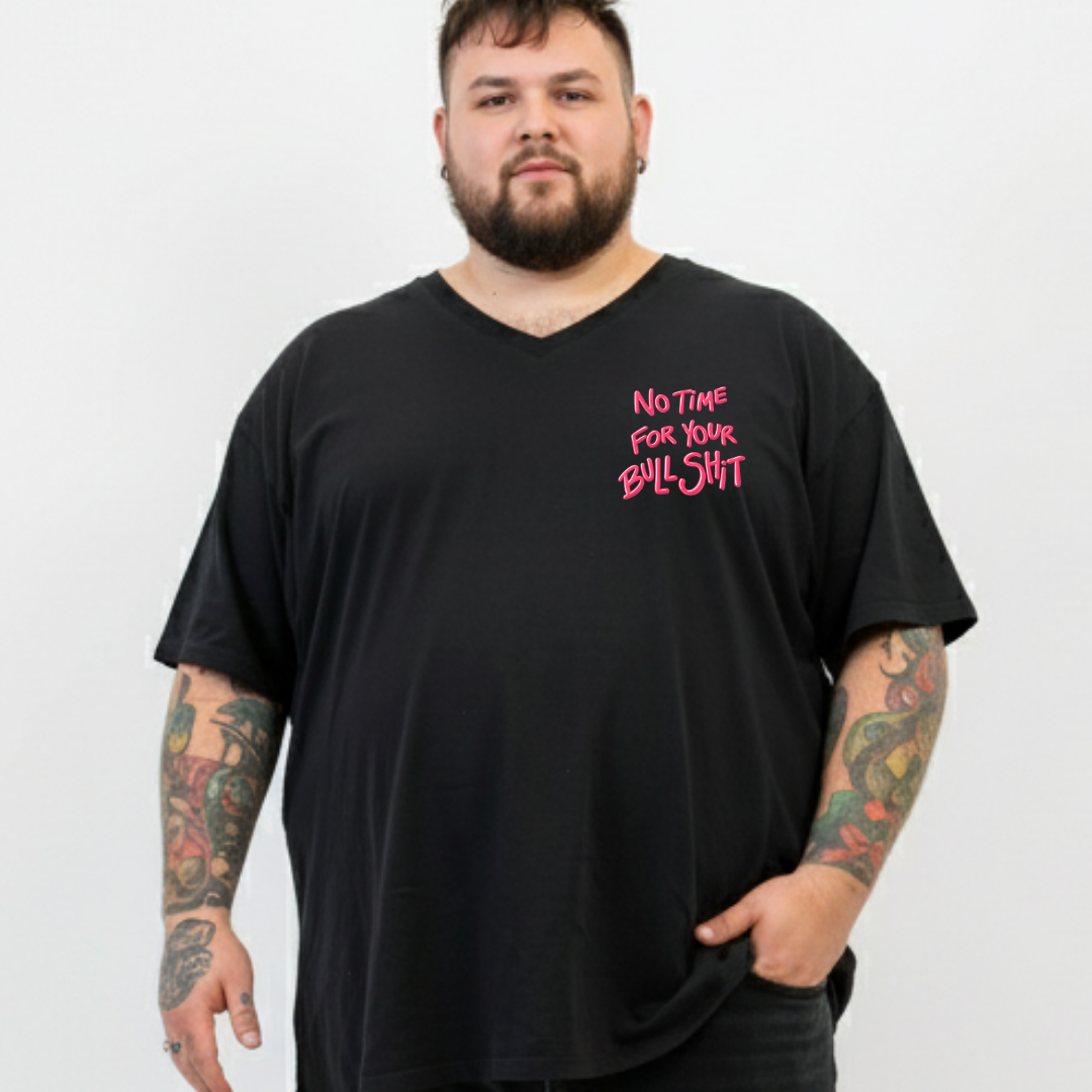 Man wearing a black t-shirt with pink text on a white background