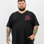 Man wearing a black t-shirt with pink text on a white background