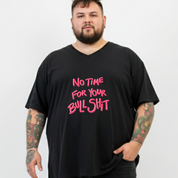 Person wearing a black t-shirt with pink text on a white background