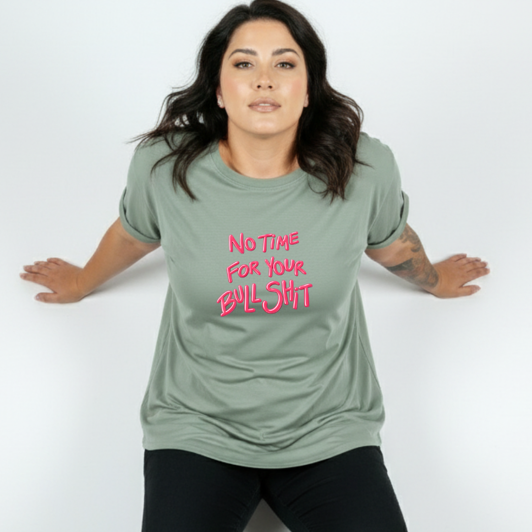 Woman wearing a green t-shirt with pink text on a white background