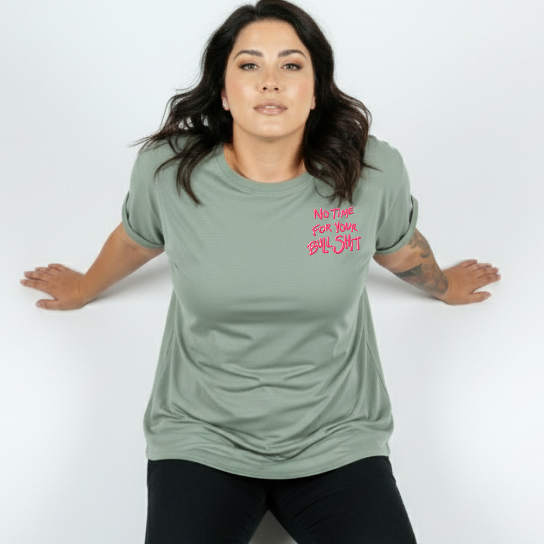 Woman wearing a green t-shirt with pink text on a white background