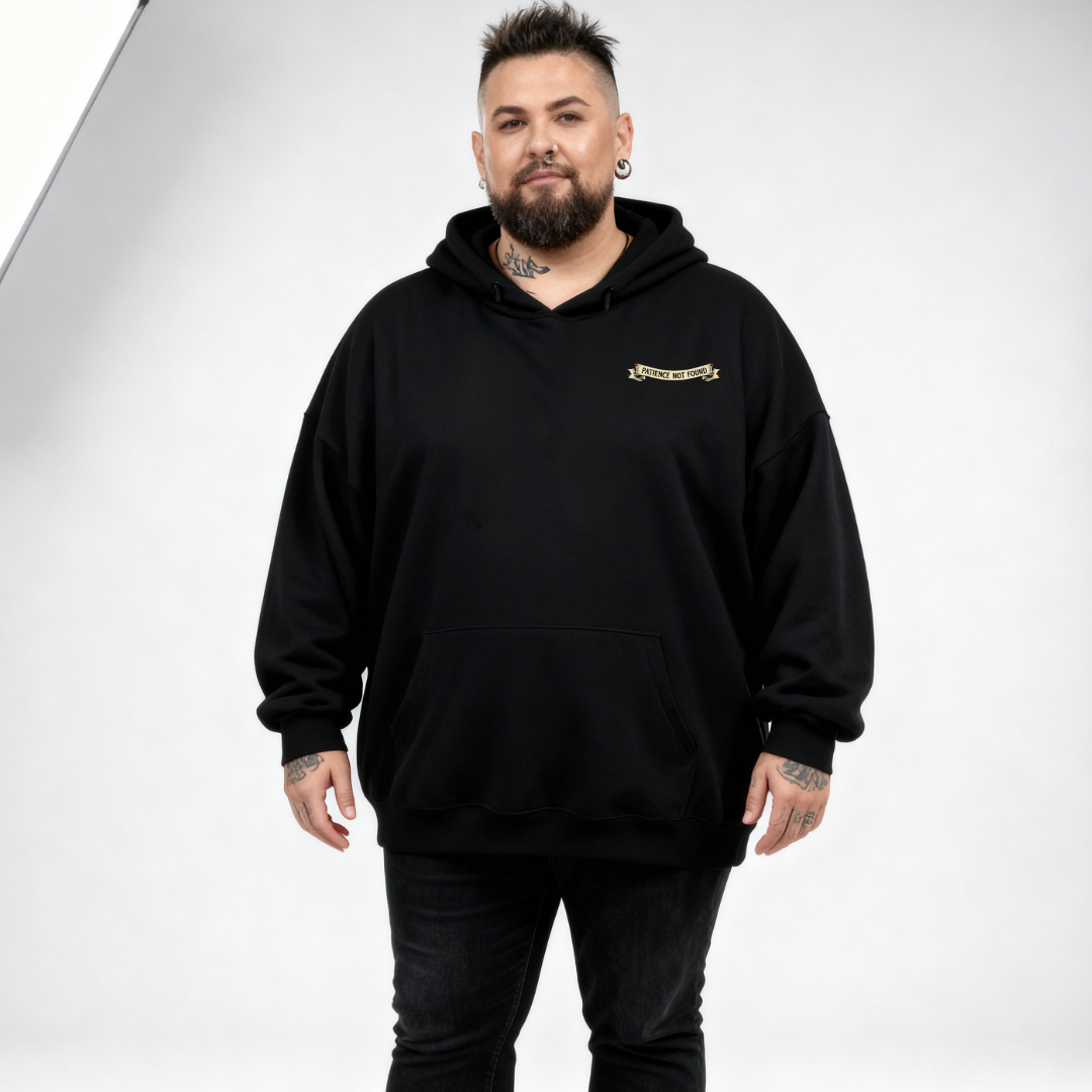 Front view of a man wearing black Error 404 Patience Not Found hoodie, relaxed fit, cyber skull graphic, plus size Australian streetwear by Bae Bands