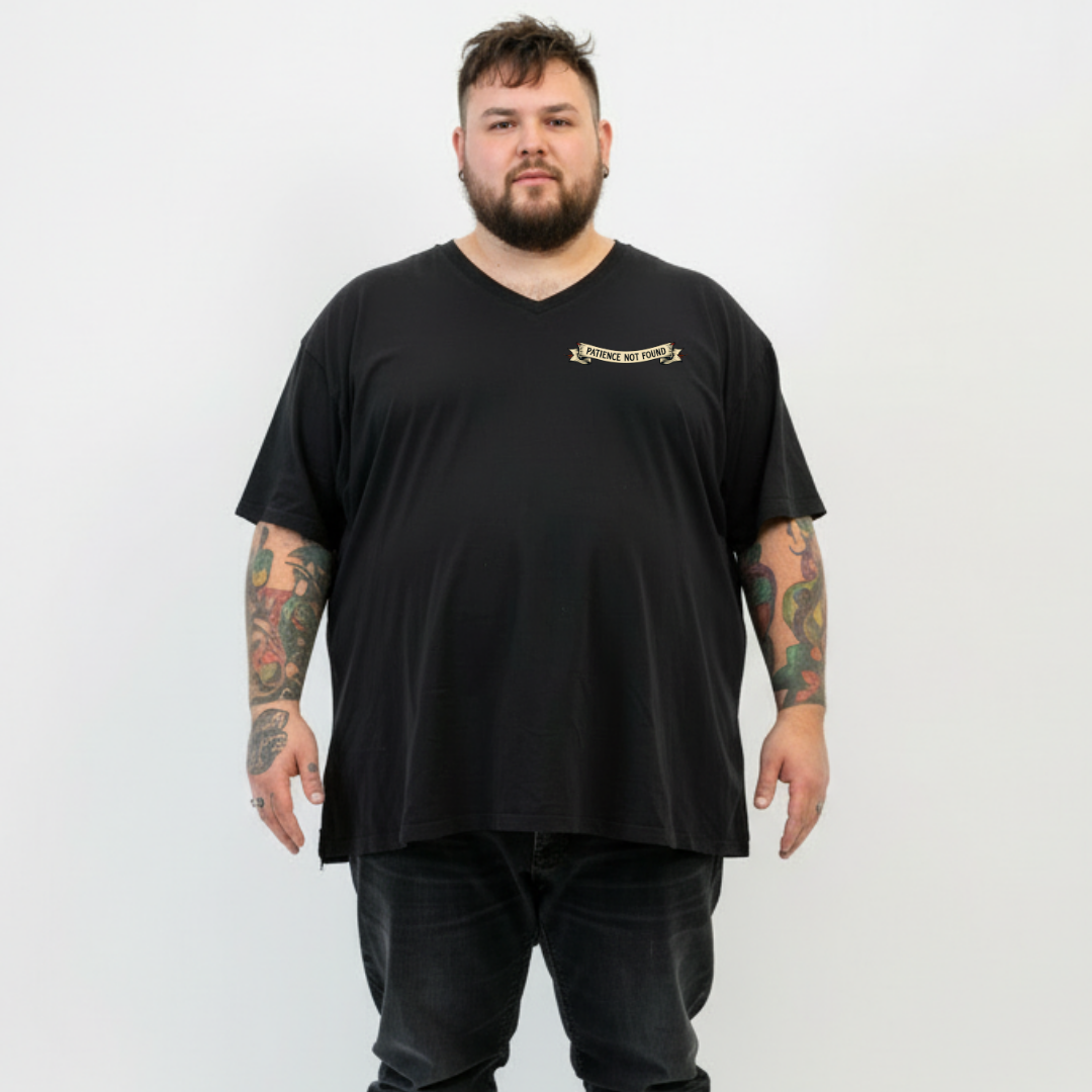 Front view of a man wearing black Error 404 Patience Not Found v neck tee, relaxed fit, cyber skull graphic, plus size Australian streetwear by Bae Bands