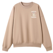A beige crewneck sweatshirt with a small graphic on the left chest featuring a colorful owl and the text 'NAMASTE MADENAS'.