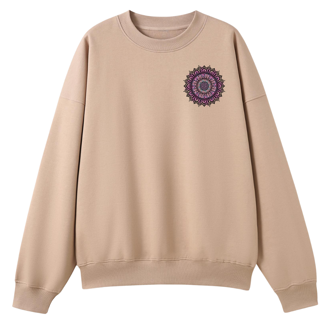 A beige crewneck sweatshirt with a purple and gray mandala graphic printed on the left chest, displayed against a solid white background.