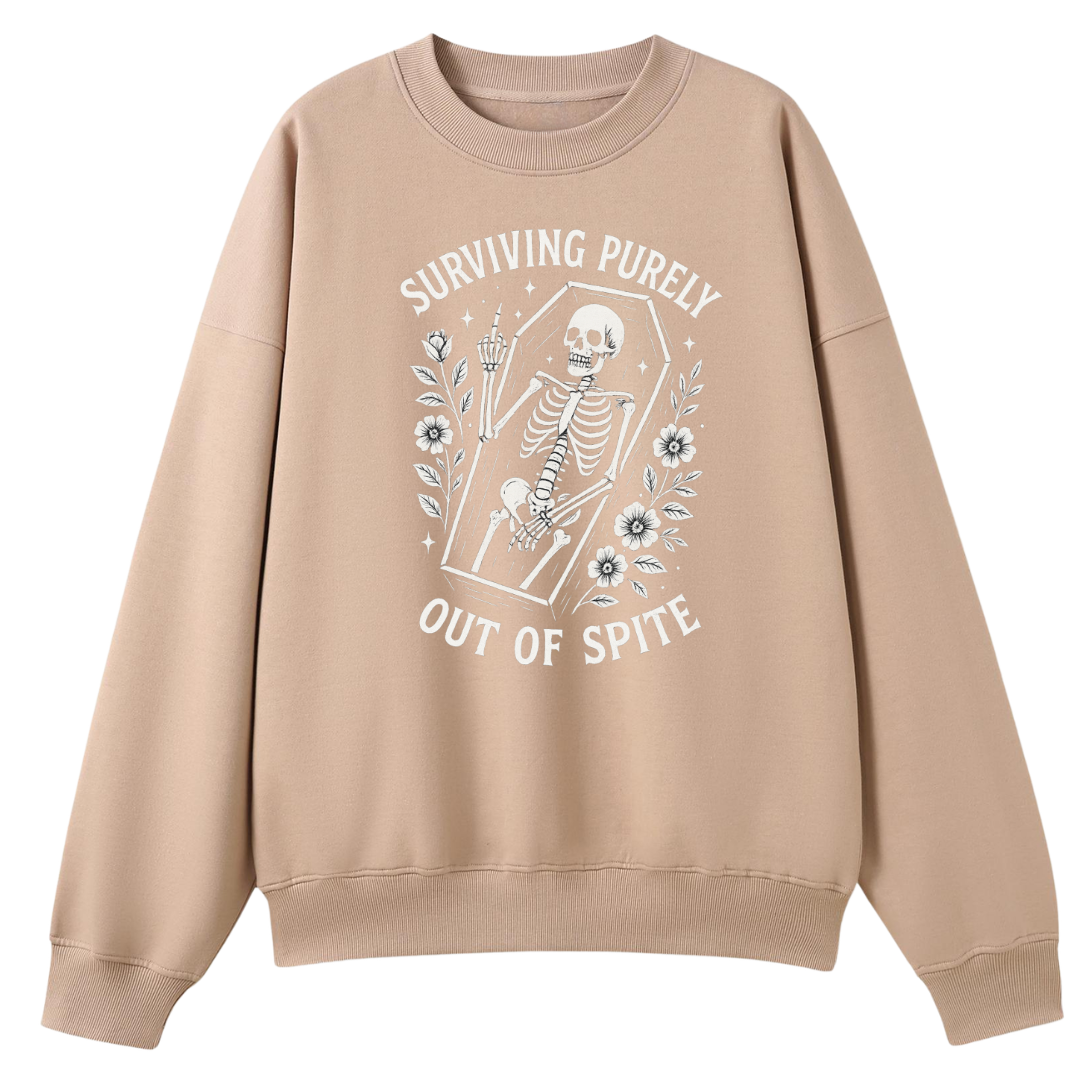 A beige crewneck sweatshirt with a white graphic print of a skeleton in a coffin and the text 'SURVIVING PURELY OUT OF SPITE' on the front, displayed against a solid white background.